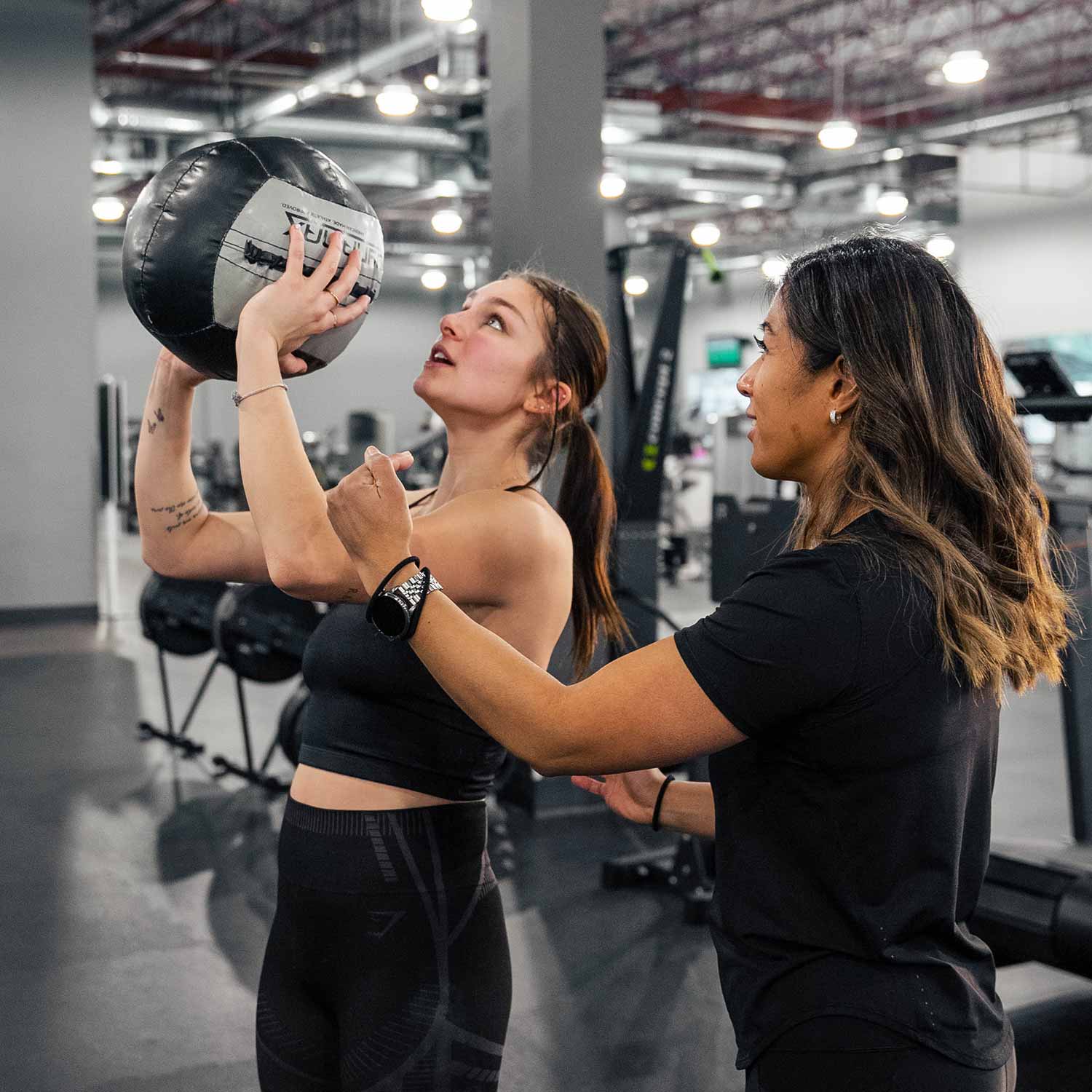 Personal trainer helping client in Edmonton